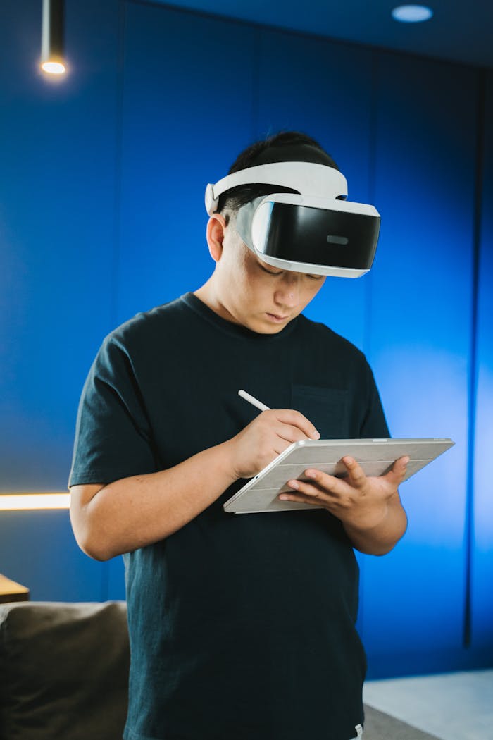 An adult using virtual reality headset with a tablet and stylus pen indoors.